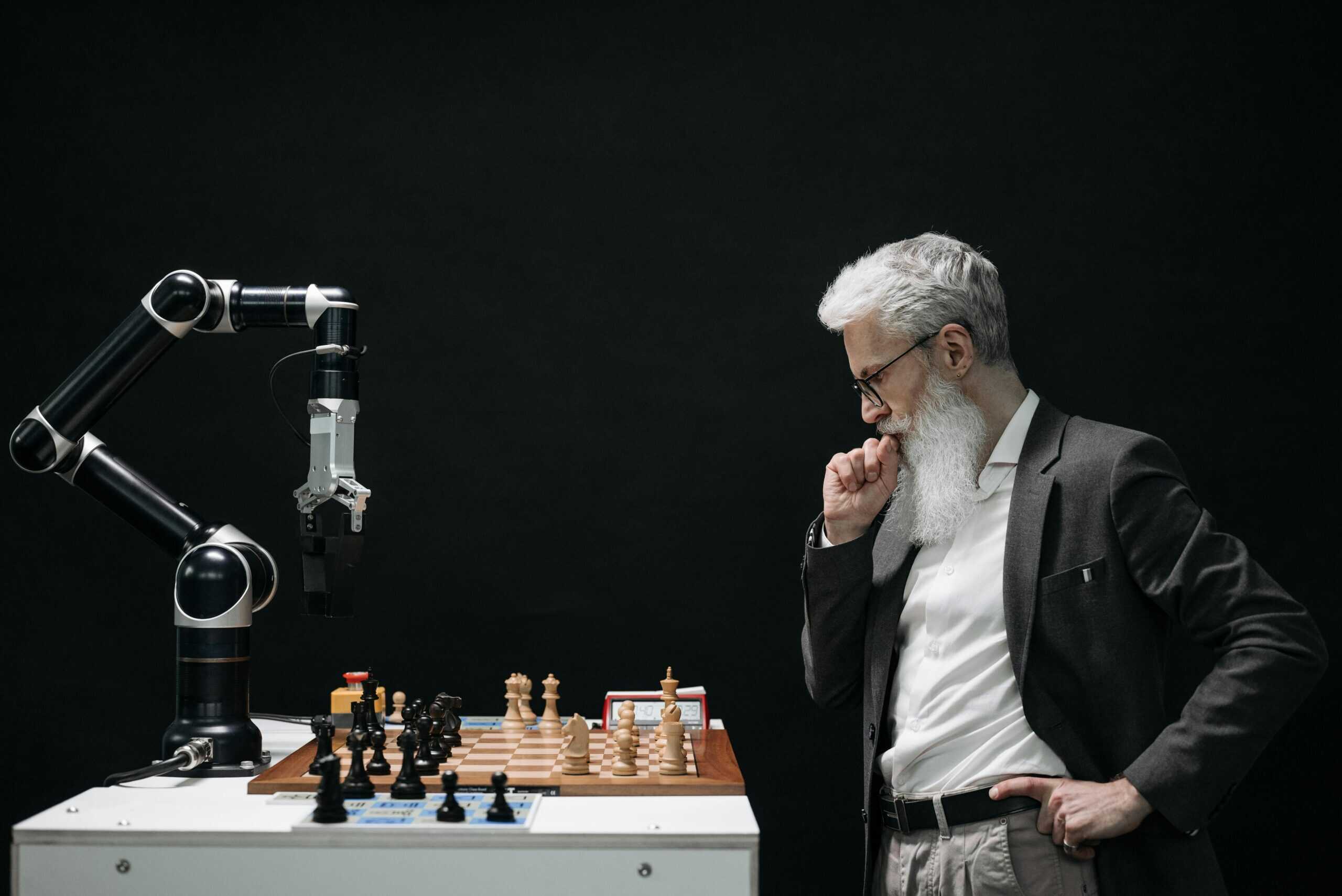 Business professional strategizing in a game of chess against a robot